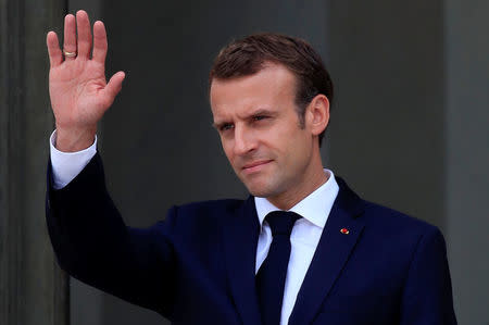 French President Emmanuel Macron accompanies a guest after a meeting at the Elysee Palace in Paris, France, July 17, 2018. REUTERS/Gonzalo Fuentes