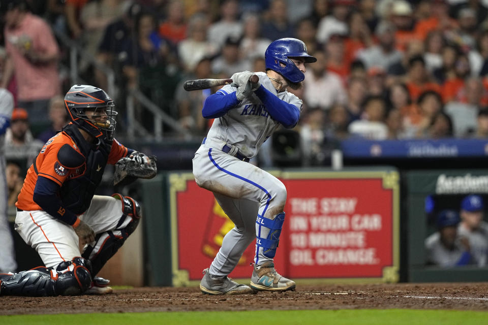 Kansas City Royals' Kyle Isbel, rigth, hits a two-run single as Houston Astros catcher Martin Maldonado watches during the sixth inning of a baseball game Friday, Sept. 22, 2023, in Houston. (AP Photo/David J. Phillip)