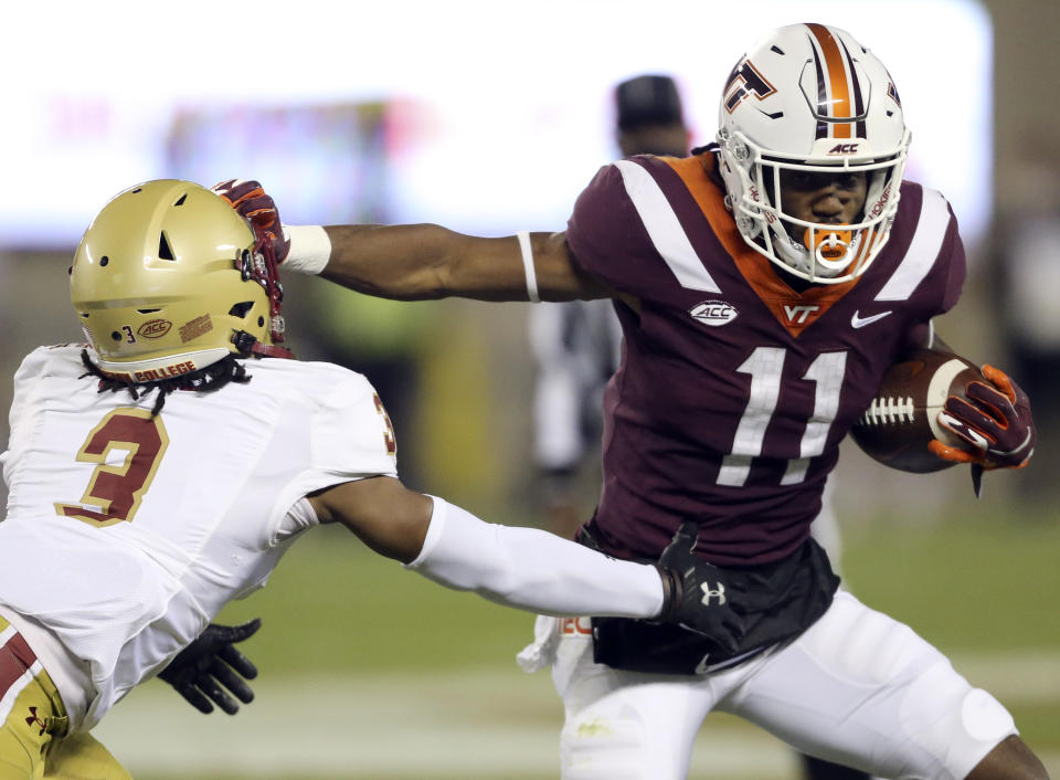 Tré Turner, right, of Virginia Tech stiff arms Jason Maitre, left, of Boston College in the first half of an NCAA college football game in Blacksburg Va. Saturday, Oct. 17, 2020. (Matt Gentry/The Roanoke Times via AP, Pool)