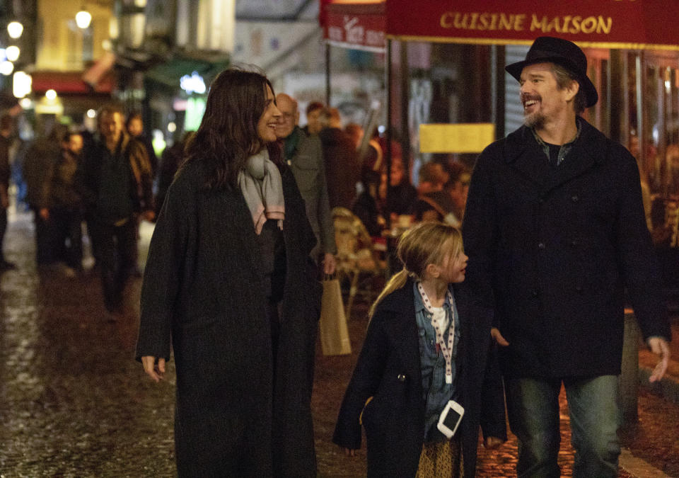 This image released by IFC Films shows, from left, Juliette Binoche, Clémentine Grenier and Ethan Hawke in a scene from "The Truth." (Laurent Champoussin/IFC Films via AP)