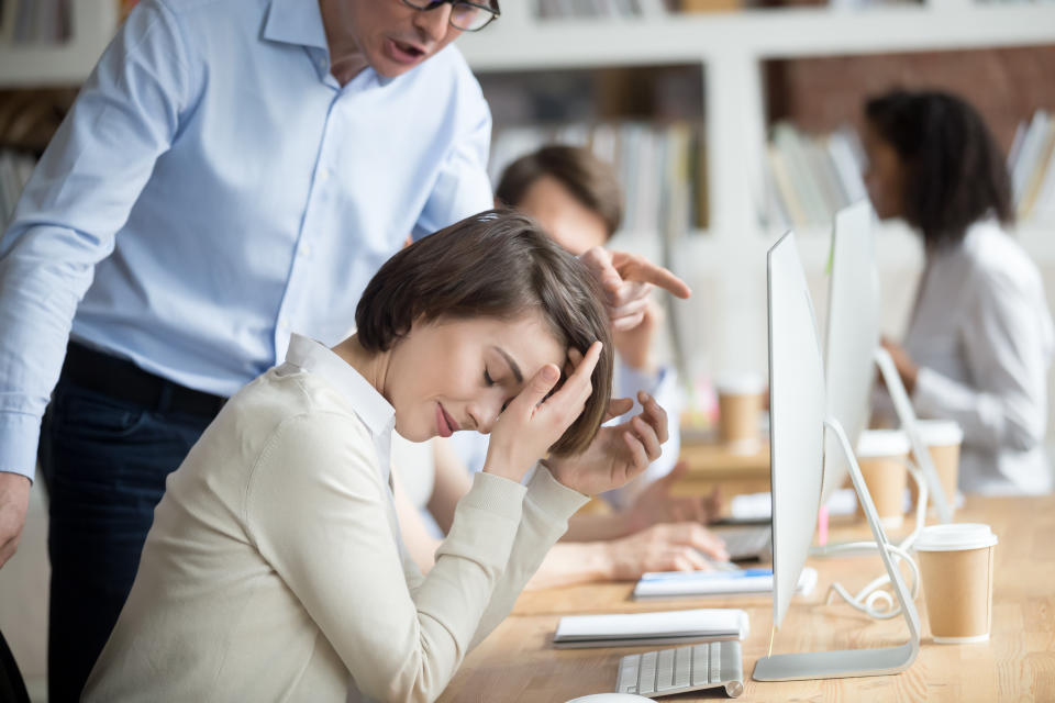 Angry irritated company boss reprimanding employee female, accusing of serious mistake and bad work. Young crying woman worker listening yelling from executive manager feels guilty frustrated unhappy