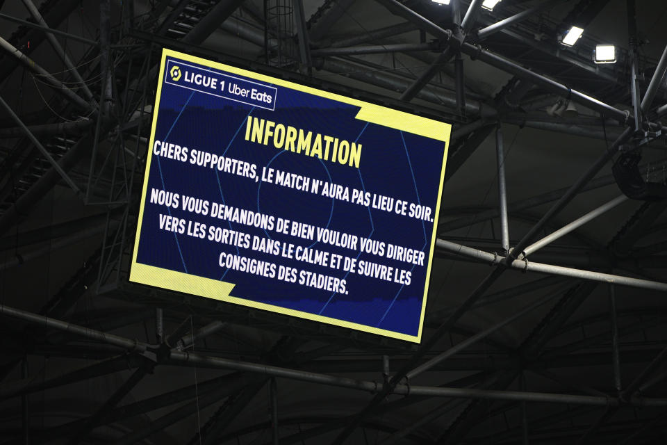 The screen with information that the French League One soccer match between Olympique de Marseille and Lyon is cancelled, at the Velodrome Stadium, in Marseille, France, Sunday, Oct. 29, 2023. (AP Photo/Daniel Cole)