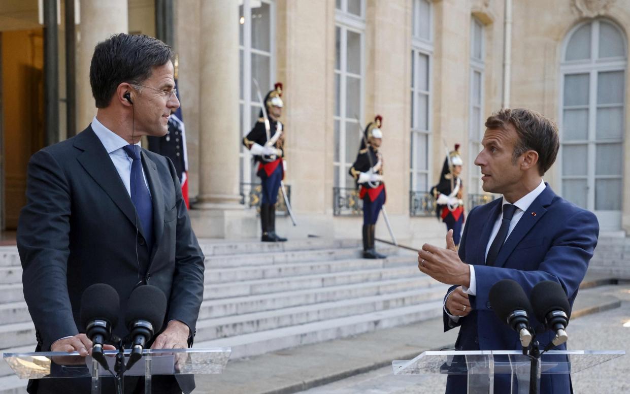 Mark Rutte, the Dutch prime minister, towers over Emmanuel Macron, the 5ft 9in tall French President during a visit to Paris in August. - AFP