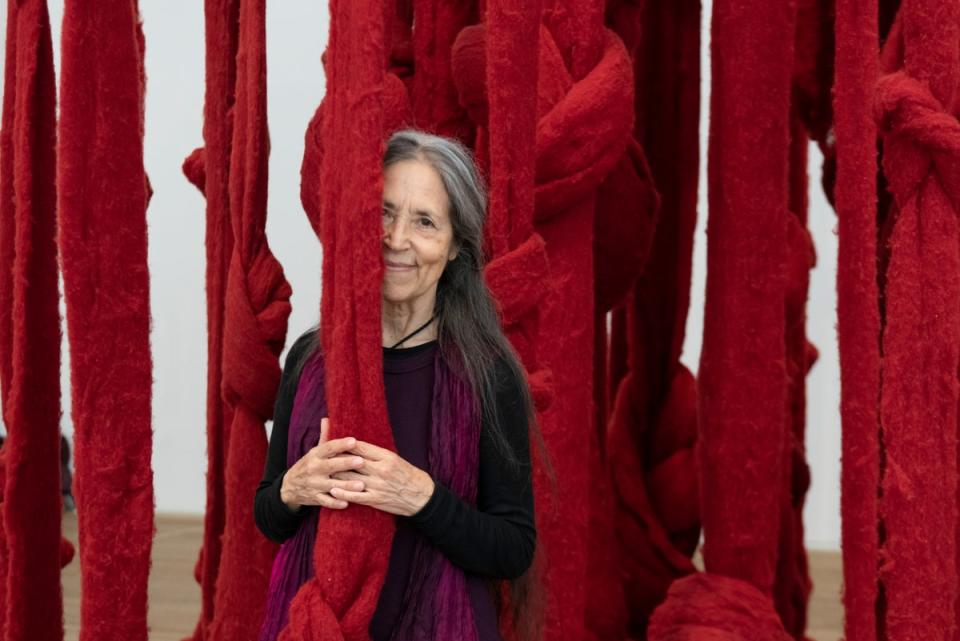 Portrait of Cecilia Vicuña in front of Quipu Womb 2017 ,at Tate Modern (Cecilia Vicuña/Tate/Lucy Dawkins)