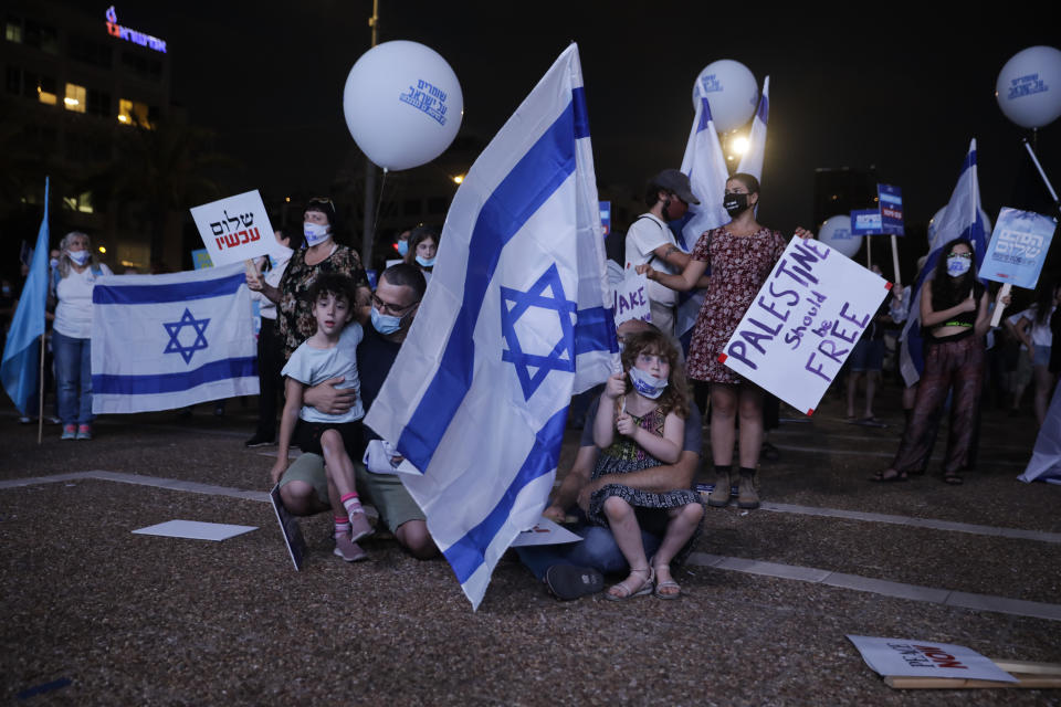 People take part in a protest against Israel's plan to annex parts of the West Bank and Trump's mideast initiative, in Tel Aviv, Israel, Tuesday, June 23, 2020. (AP Photo/Sebastian Scheiner)