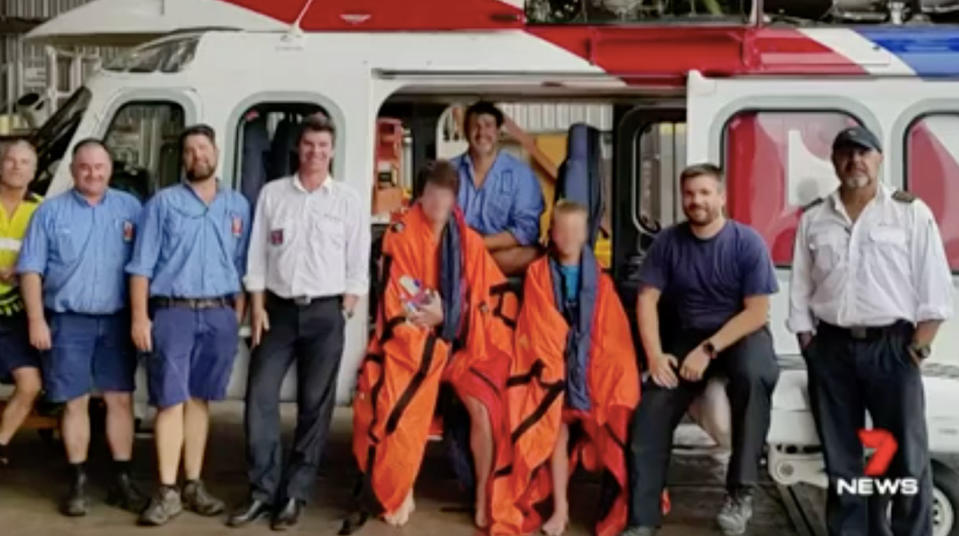 The team that helped find the stranded brothers, pictured centre. Source: 7 News