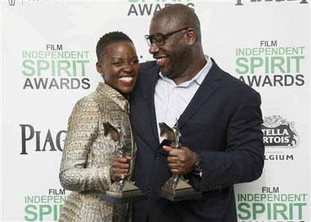 Actress Lupita Nyong'o and director Steve McQueen pose with their awards for "12 Years a Slave" backstage at the 2014 Film Independent Spirit Awards in Santa Monica, California March 1, 2014. REUTERS/Danny Moloshok