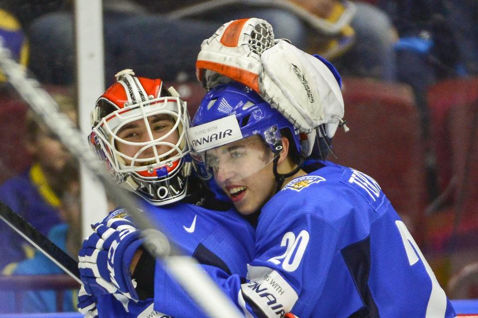 Finland's Teuvo Teravainen, right, hugs the goalie Juuse Saros, left, after their team's 5-3 in the World Junior Hockey Championships quarter final between Finland and Czech Republic at the Malmo Arena in Malmo, Sweden on Thursday, Jan. 2, 2014. (AP photo?TT News Agency, Ludvig Thunman) SWEDEN OUT