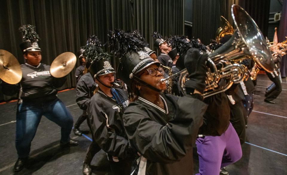 Burncoat High School musicians, including mellophone player Natalie Osei, center, rehearse before a performance Tuesday at Worcester Technical High School.