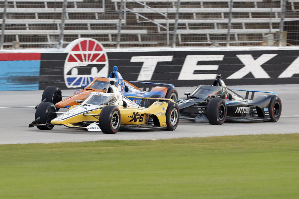 Josef Newgarden, front, Scott Dixon, rear, and Felix Rosenqvist, right, race down the front stretch during an IndyCar auto race at Texas Motor Speedway in Fort Worth, Texas, Saturday, June 6, 2020. (AP Photo/Tony Gutierrez)