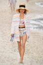 <p>Passend zur Strandatmosphäre durfte der Bikini in der neusten Frühjahrs-/Sommerkollektion von Chanel nicht fehlen: Ein klassischer High-Waist-Zweiteiler mit bunten Prints. Dazu trug das Model einen Oversize-Blazer, dezente Goldkettchen und Strohhut. (Bild: Getty Images) </p>