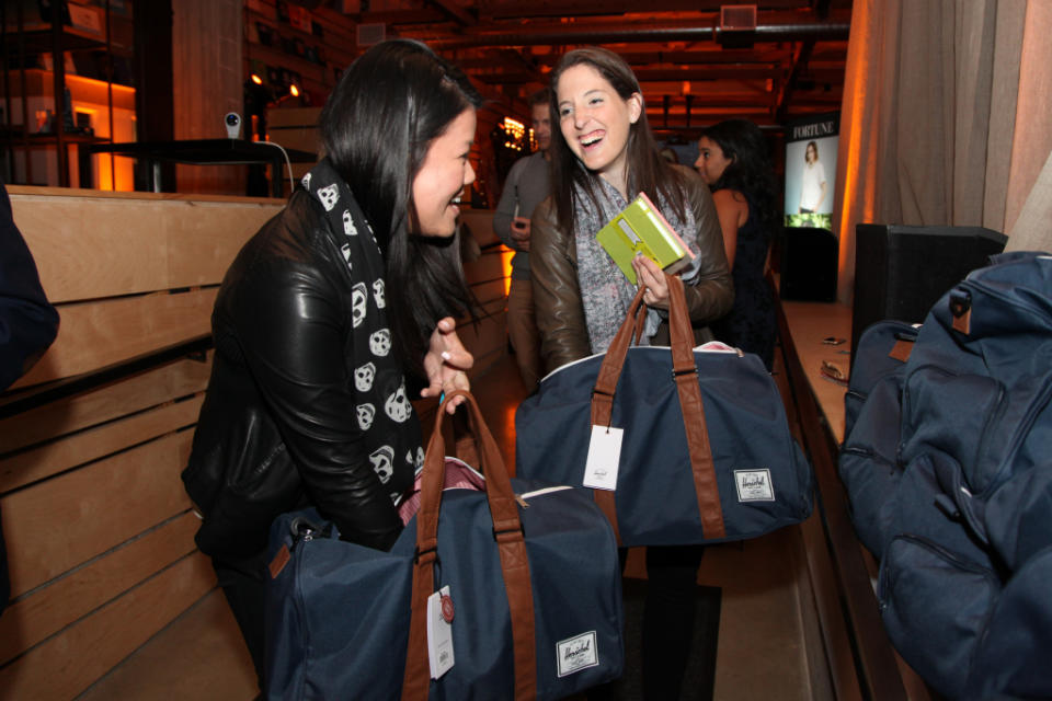 Rachel Holt, right, Head of North American Operations at Uber and 2016 honoree on Fortune's 40 Under 40 list, and MoMo Zhou, Corporate Communications at Uber, checks out the party gift bag contents.