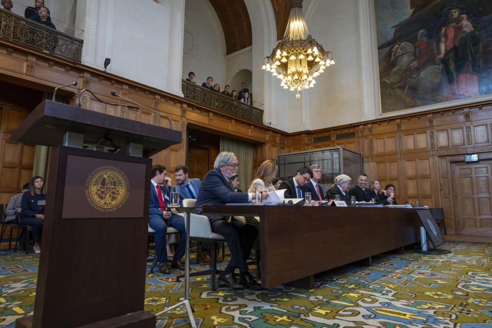 Ecuador's ambassador Andres Teran Parral, left, and agent Ana Maria Larrea, second left, wait for judges to enter the International Court of Justice, or World Court, in The Hague, Netherlands, Wednesday, May 1, 2024. Mexico is taking Ecuador to the United Nations' top court on Tuesday accusing the nation of violating international law by storming into the Mexican embassy in Quito on April 5, and arresting former Ecuador Vice President Jorge Glas, who had been holed up there seeking asylum in Mexico. (AP Photo/Peter Dejong)