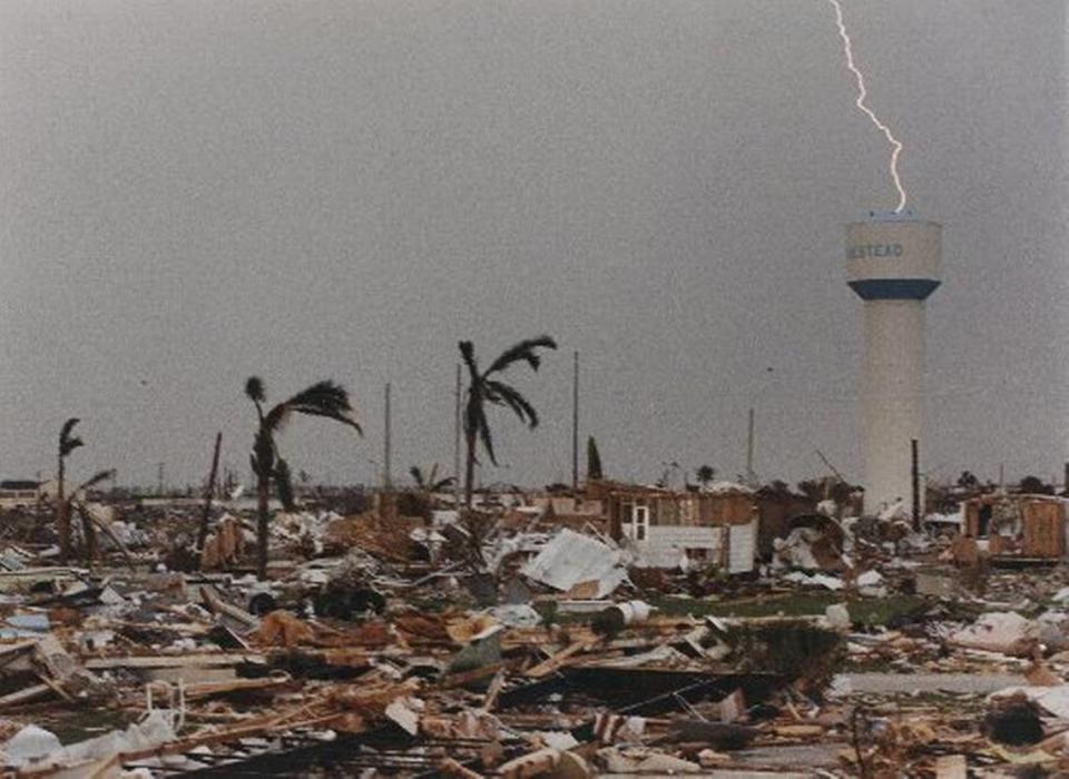 On the seventh day after the storm, thunderstorms sweep through South Miami-Dade, once again drenching furniture in exposed houses and leaving many people mired in mud. This stark scene, near the Homestead city hall, shows graphically the devastation the city suffered.