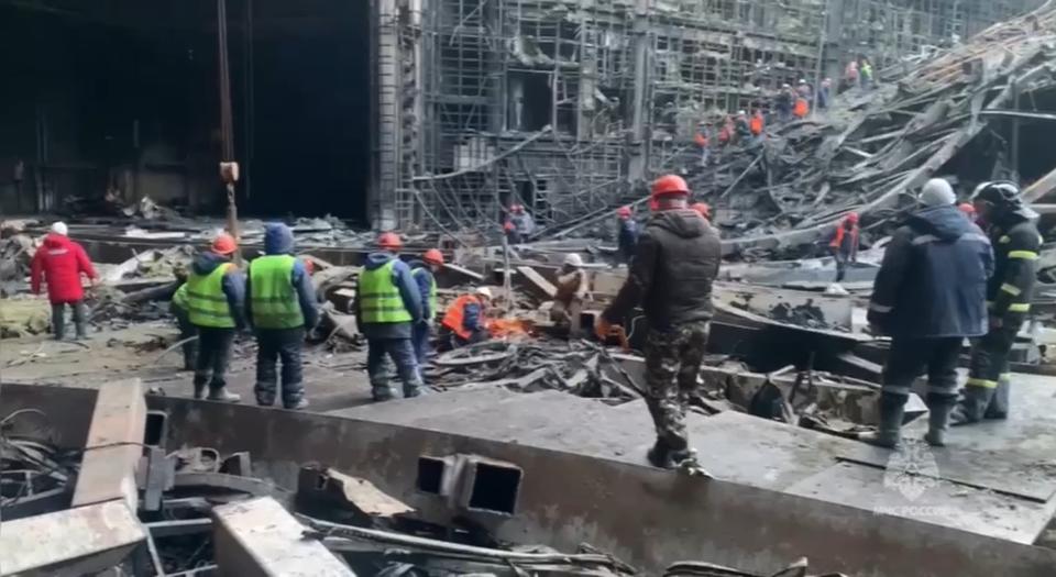 In this photo taken from video released by Russian Emergency Ministry Press Service on Tuesday, March 26, 2024, rescuers work in the burned concert hall after a terrorists attack on the building of the Crocus City Hall on the western edge of Moscow, Russia. Russia is still reeling from the attack Friday in which gunmen killed 139 people in the Crocus City Hall, a concert venue on the outskirts of Moscow. Health officials said about 90 people remain hospitalized, with 22 of them, including two children, in grave condition. (Russian Emergency Ministry Press Service via AP)