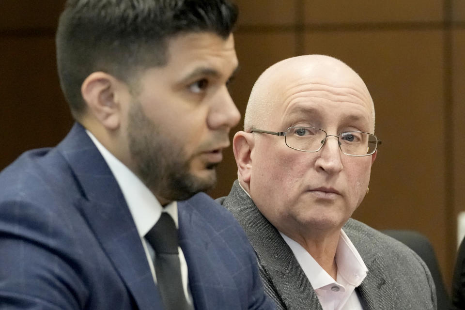 Robert E. Crimo Jr., right, father of Robert Crimo III, listens to his attorney George Gomez during an appearance before Judge George D. Strickland at the Lake County, Ill., Courthouse Thursday, Jan. 26, 2023, in Waukegan, Ill. Crimo Jr., faces seven counts of felony reckless conduct for signing the application for his son's firearm owners ID card in December of 2019. (AP Photo/Nam Y. Huh, Pool)