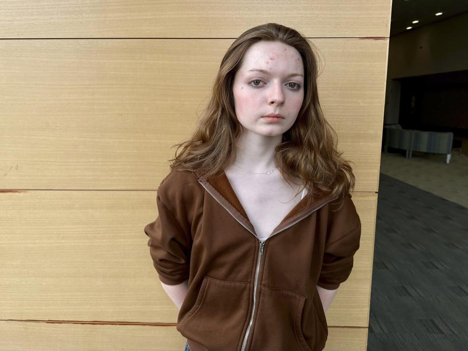 Shae Ross, a senior at Jefferson High School, pose for a photo April, 19, 2024, in Bloomington, Minn. Ross and other students successfully campaigned their district not to ban certain books dealing with sexuality, gender and race after some parents objected to their presence in classrooms and libraries. (AP Photo/Mark Vancleave)