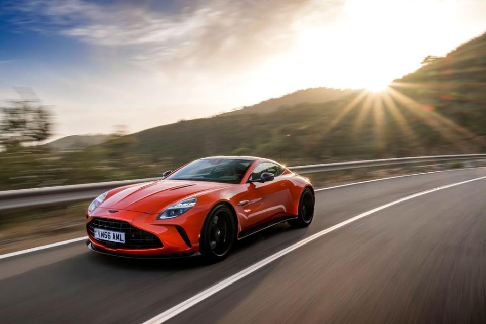 a red sports car driving on a road