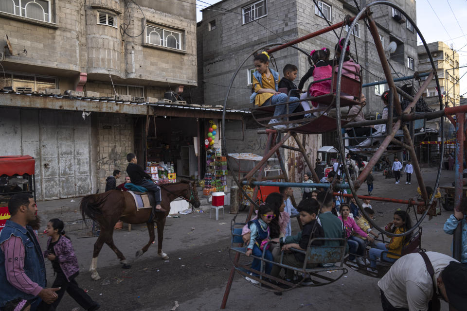 Palestinians celebrate Eid al-Fitr festival, marking the end of the fasting month of Ramadan at al-Shati refugee camp, western Gaza Strip, Saturday, April 22, 2023. (AP Photo/Fatima Shbair)