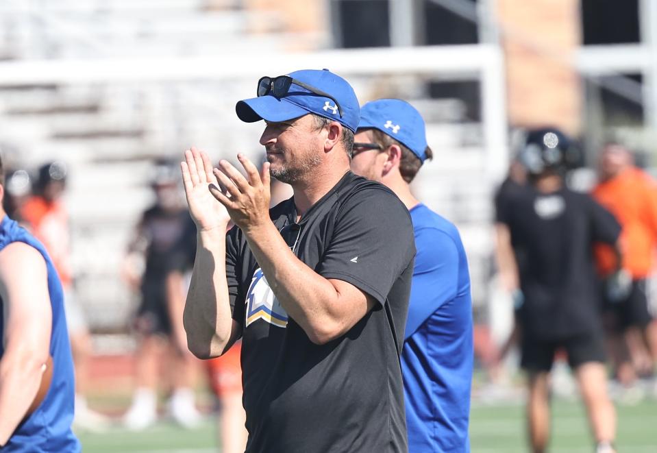 Madeira head football coach Chris Stewart encourages his players during the Mustangs' 7-on-7 at Anderson High School Wednesday, June 22, 2022.
