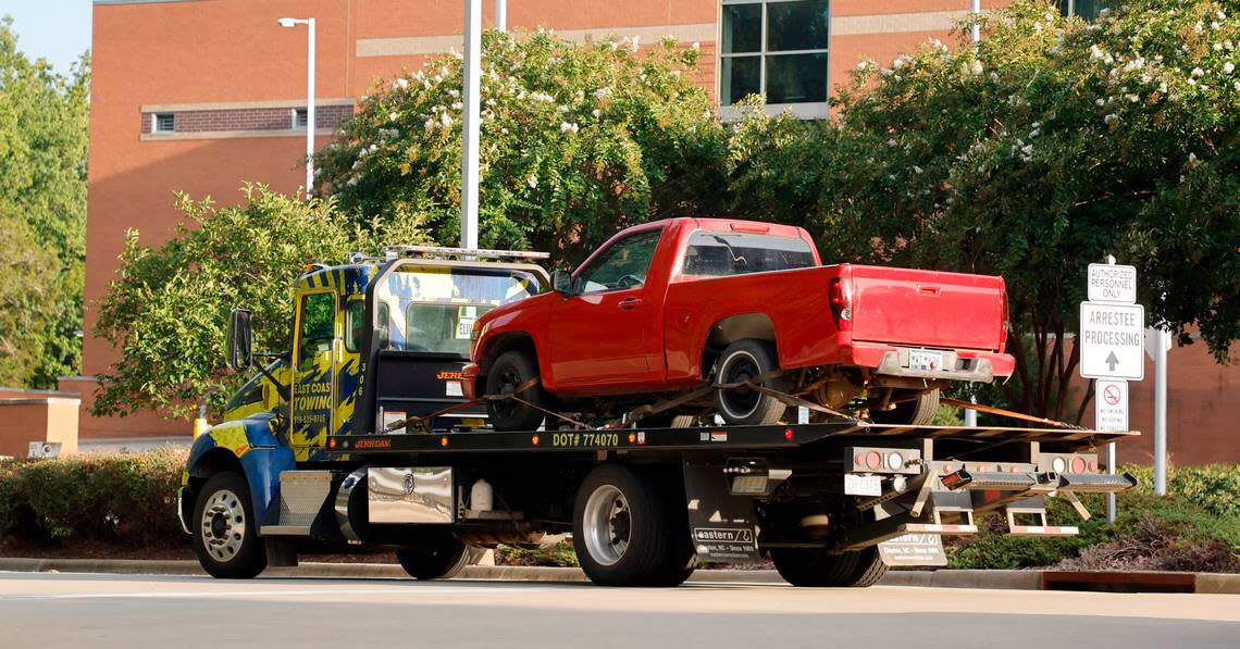 A red pickup truck is transported to the Wake County Detention Center/City-County Bureau of Identification in Raleigh, N.C., Wednesday, August 17, 2022. The truck was seized by law enforcement officials on Wednesday in Winston-Salem in the investigation of the killing of Wake County Deputy Ned Byrd, according to someone with knowledge of the investigation.