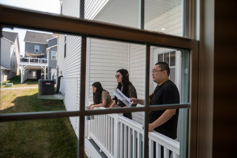 Prospective home buyers look from the balcony of a home for sale during an Open House in a neighborhood in Clarksburg, Maryland. (Credit: Roberto Schmidt, AFP via Getty Images)