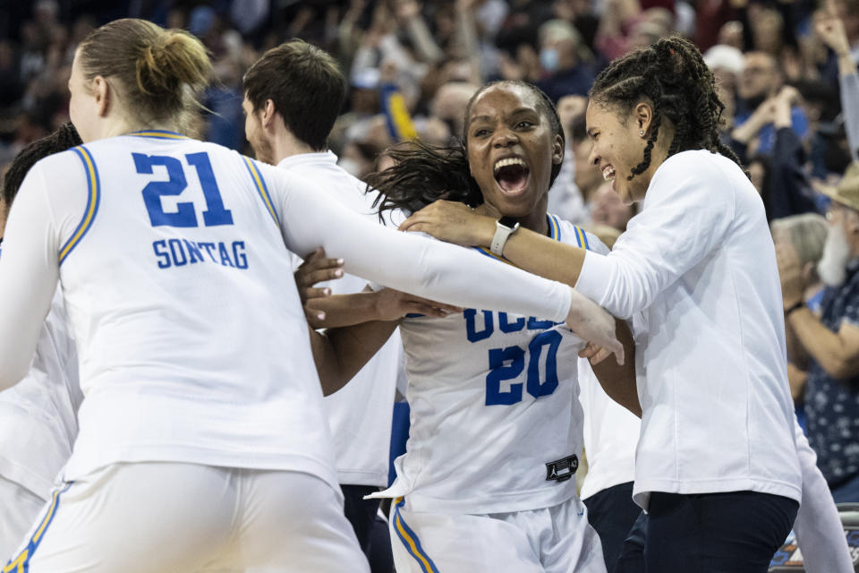 UCLA guard Charisma Osborne (20) celebrates the team's 82-73 win with her teammates in a second-round college basketball game against Oklahoma in the NCAA Tournament, Monday, March 20, 2023, in Los Angeles. (AP Photo/Kyusung Gong)