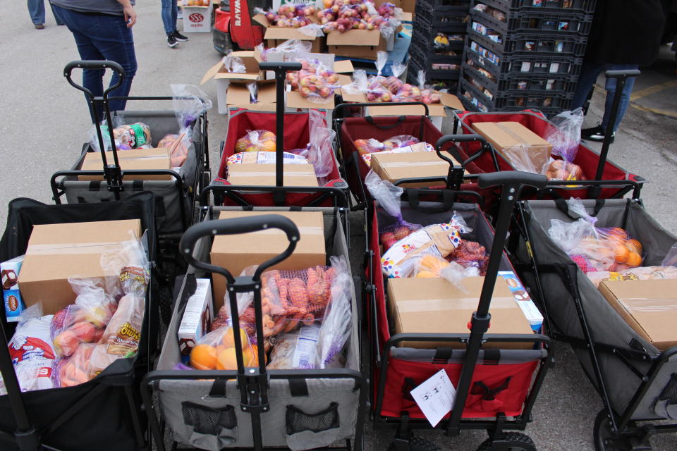 Food Bank for the Heartland volunteers and staff distribute food kits at an emergency drive-up mobile pantry in Omaha during the COVID-19 pandemic.  