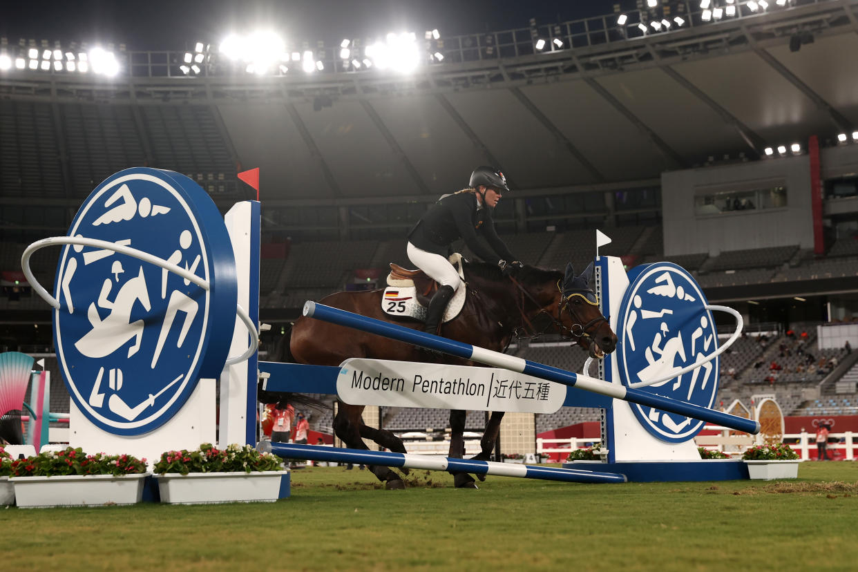 Annika Schleu of Germany fails a jump during the riding show jumping of the women's modern pentathlon at the Tokyo Olympics. (Dan Mullan/Getty Images)