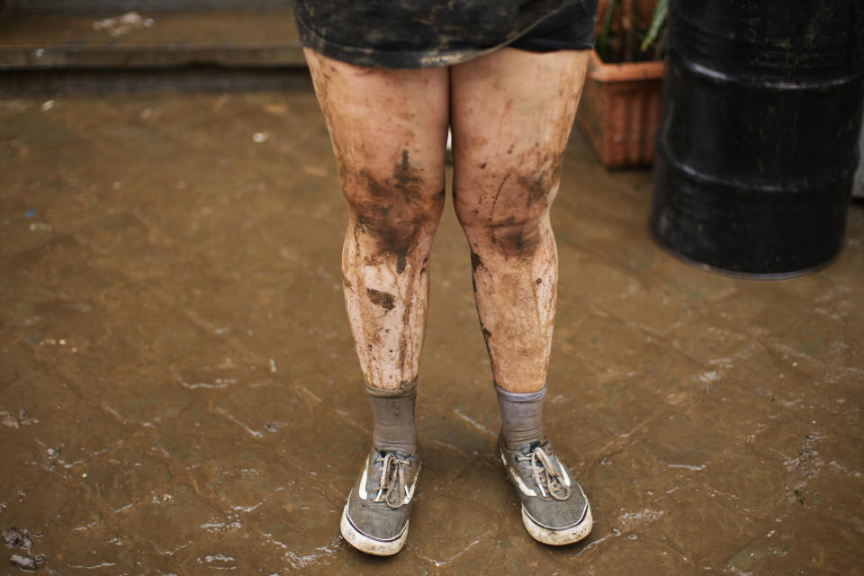 FILE - In this Friday, July 16, 2021 file photo, awoman stands outside while cleaning mud and water out of her house after flooding in Ensival, Verviers, Belgium, Scientists say there’s something different this year from the recent drumbeat of climate weirdness. This summer a lot of the places hit by weather disasters are not used to getting extremes and many of them are wealthier, which is different from the normal climate change victims. That includes unprecedented deadly flooding in Germany and Belgium, 116-degree heat records in Portland, Oregon and similar blistering temperatures in Canada, along with wildfires. Now Southern Europe is seeing scorching temperatures and out-of-control blazes too. And the summer of extremes is only getting started. Peak Atlantic hurricane and wildfire seasons in the United States are knocking at the door. (AP Photo/Francisco Seco, File)