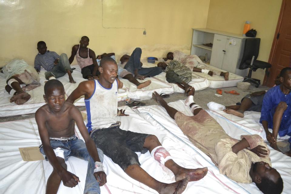 FILE- In this Monday, Sept. 21, 2015 file photo, Victims receive treatment at a hospital, after an explosion in Maiduguri, Nigeria. Nigerian President Muhammadu Buhari's nearly month-long medical leave in London is reminding his country's taxpayers that while they finance their leaders' health care abroad, they often are stuck with decrepit, ill-staffed government health facilities at home. (AP Photo/Jossy Ola File)