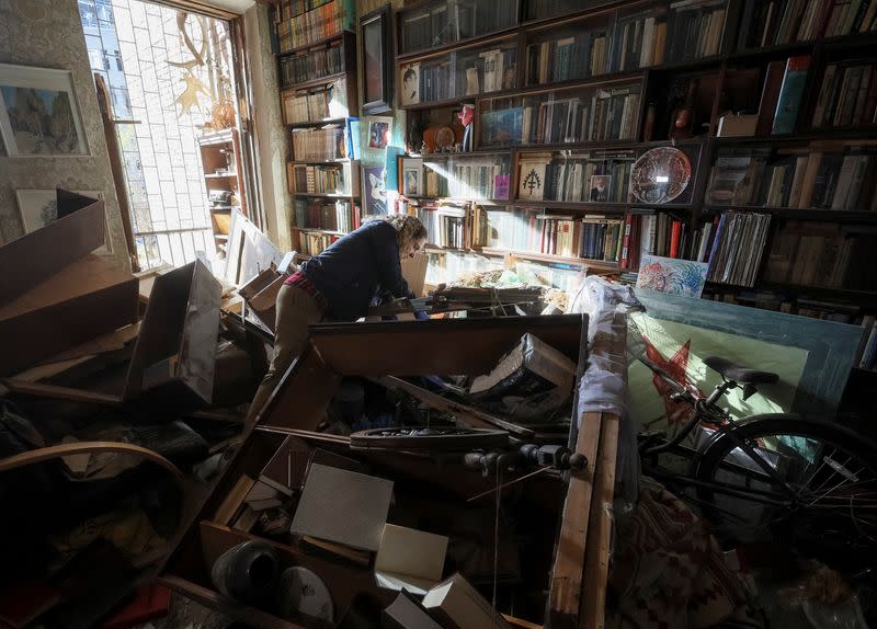 Local resident Yulia Datsenko, 38, stands in her flat, damaged by the previous day's Russian military strike, as Russia's attack on Ukraine continues, in central Kyiv