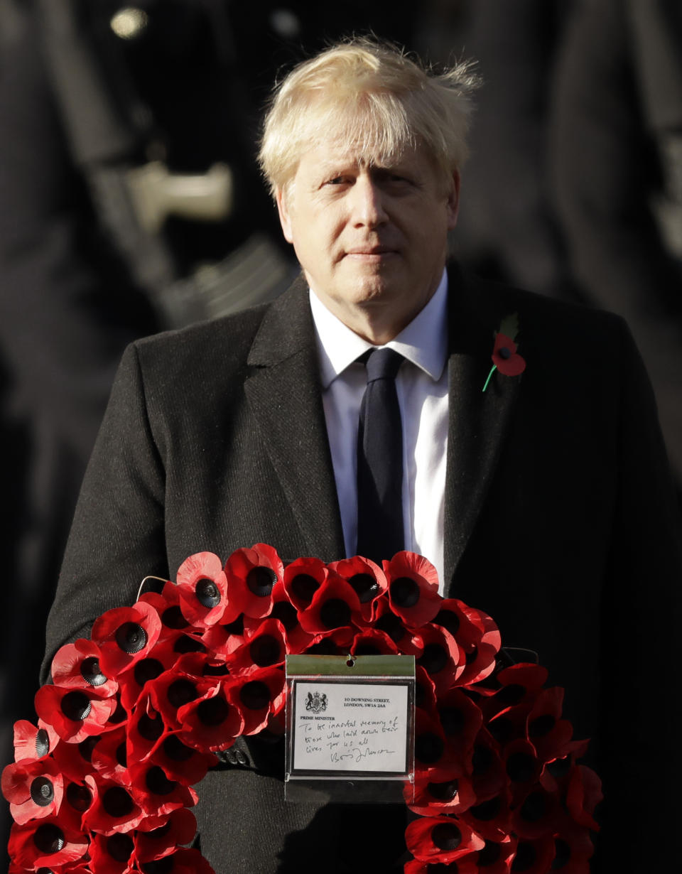 British Prime Minister Boris Johnson prepares to lay a wreath during the Remembrance Sunday ceremony at the Cenotaph in Whitehall in London, Sunday, Nov. 10, 2019. Remembrance Sunday is held each year to commemorate the service men and women who fought in past military conflicts. (AP Photo/Matt Dunham)