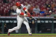 Cincinnati Reds' Eugenio Suarez hits a solo home run during the fifth inning of a baseball game against the Pittsburgh Pirates in Cincinnati, Monday, Sept. 20, 2021. (AP Photo/Aaron Doster)