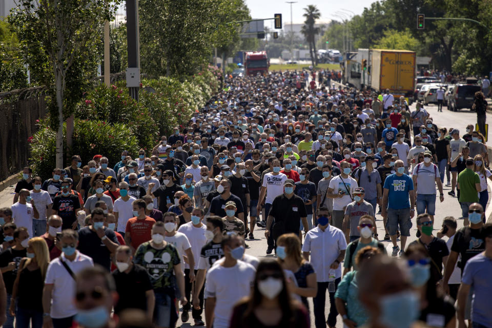 Nissan workers march during a protest in Barcelona, Spain, Thursday, May 28, 2020. Japanese carmaker Nissan Motor Co. has decided to close its manufacturing plans in the northeastern Catalonia region, resulting in the loss of some 3,000 direct jobs. (AP Photo/Emilio Morenatti)