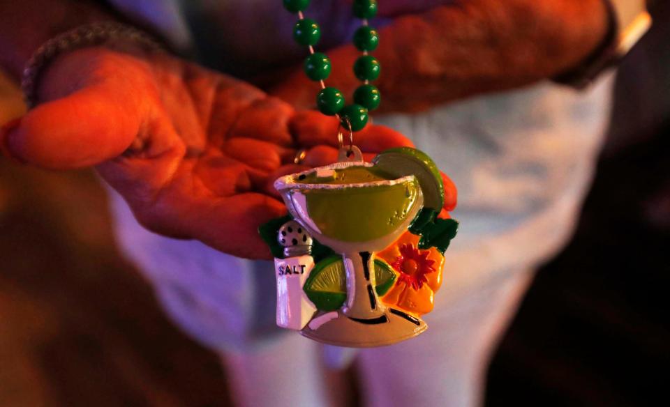 Amy Webster, member of The Parrot Head Club of Memphis can be seen wearing a margarita with salt necklace at a get-together to honor Jimmy Buffett at Lafayette's Music Room in Memphis, Tenn., on Sept. 4, 2023. Amy has been a fan since 1978.