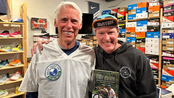 Travis Macy at a book reading with his father.