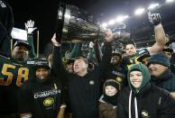 Edmonton Eskimos head coach Chris Jones (C) raises the Grey Cup after his team defeated the Ottawa Redblacks in the CFL's 103rd Grey Cup championship football game in Winnipeg, Manitoba, November 29, 2015. REUTERS/Mark Blinch