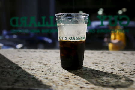 A coffee cup of a nitrogen-infused cold brew coffee from Brooklyn-based roaster Gillies Coffee out of a tap is seen at Guy & Gallard cafeteria in New York July 31, 2015. REUTERS/Eduardo Munoz