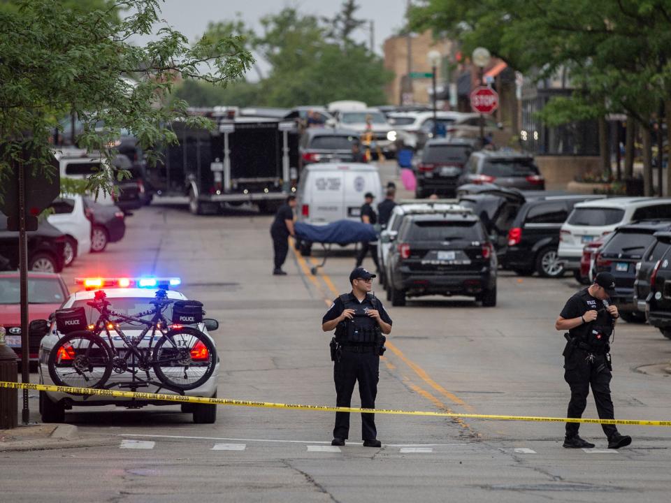 First responders take away victims from the scene of a mass shooting at a Fourth of July parade on July 4, 2022 in Highland Park, Illinois.