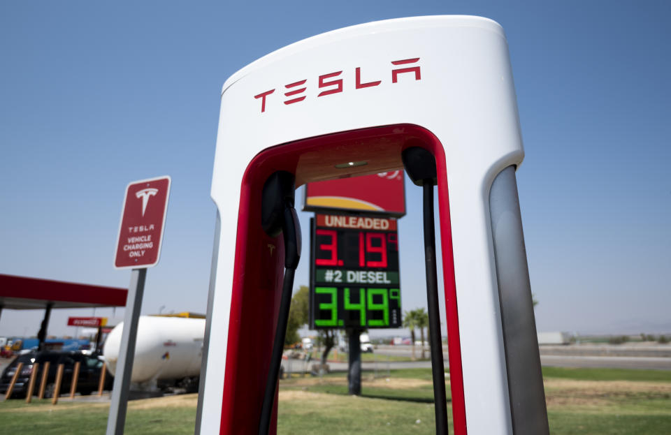 UNITED STATES - AUGUST 24: Gasoline prices are seen behind Tesla charging stations stand at an interstate highway exit in Ehrenberg, Ariz., on Tuesday, August 24, 2021. (Photo by Bill Clark/CQ-Roll Call, Inc via Getty Images)