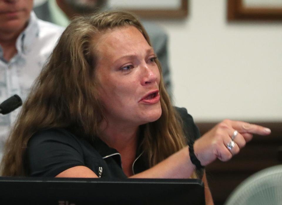 Katelin Puzakulics, daughter of slain Rachael Johnson, points to Daniel Rees as she gives her impact statement during Rees' hearing Friday in Akron.