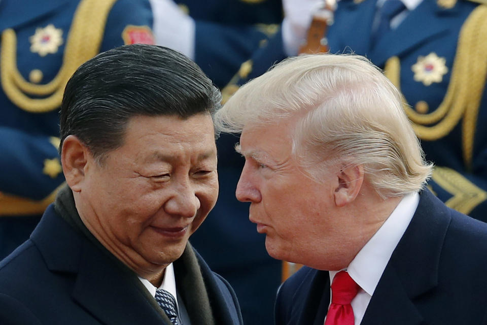 FILE - In this Nov. 9, 2017, file photo, U.S. President Donald Trump, right, chats with Chinese President Xi Jinping during a welcome ceremony at the Great Hall of the People in Beijing. The White House’s move to expand Washington’s dispute with Beijing beyond trade and technology and into accusations of political meddling have sunk relations between the world’s two largest economies to their lowest level since the end of the Cold War. (AP Photo/Andy Wong, File)