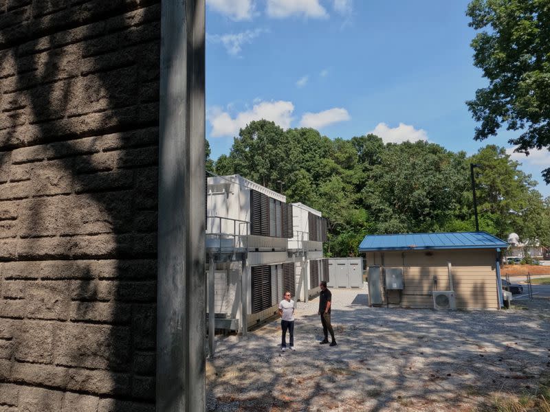 CleanSpark CEO Zach Bradford and Executive Chairman Matt Schultz chat next to the company's CleanBlock site in Georgia, behind a soundproofing wall. (Eliza Gkritsi/CoinDesk)