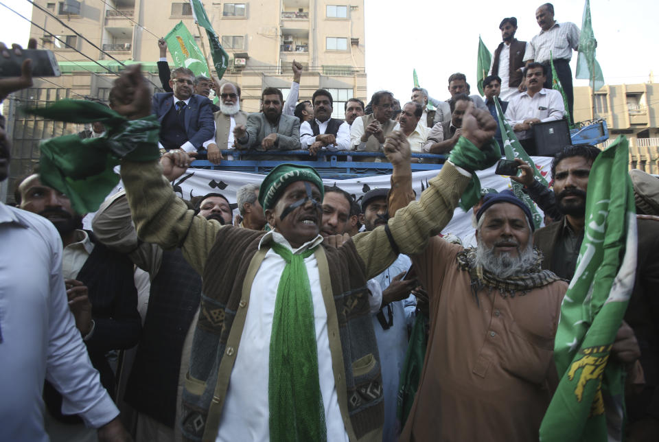 Supporters of former Pakistani Prime Minister Nawaz Sharif protest against a court ruling, in Karachi, Pakistan, Monday, Dec. 24, 2018. An anti-graft tribunal sentenced Sharif to seven years in prison for corruption on Monday, drawing criticism from his party, which said the decision was a "black stain" on the justice system. The same court acquitted Sharif in a second case relating to his family's business in Britain. (AP Photo/Fareed Khan)