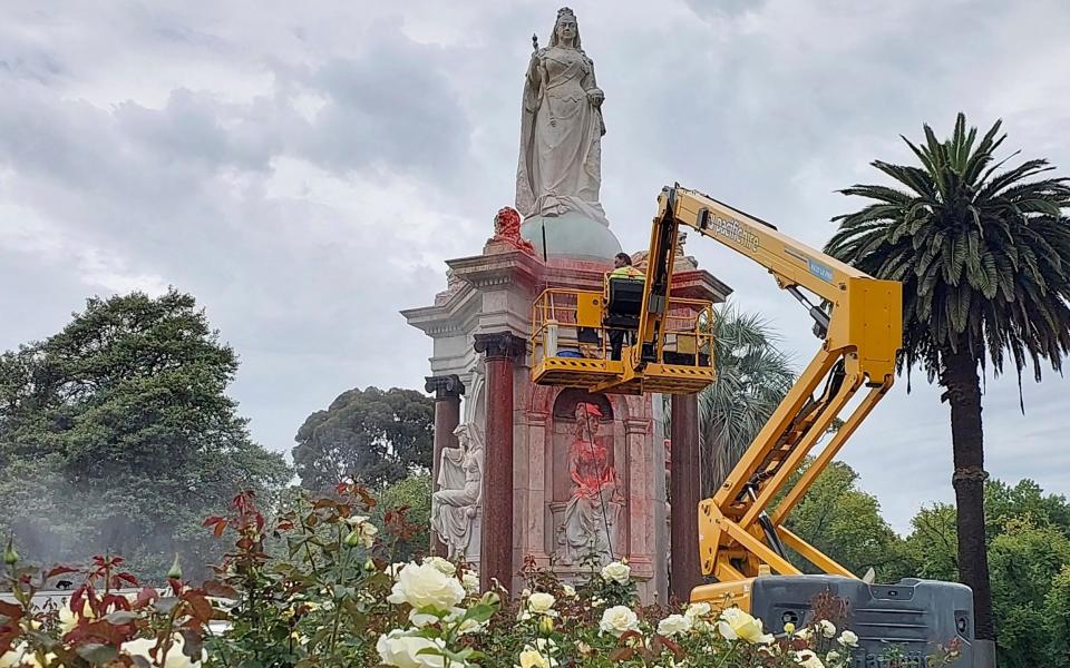 A council worker cleaning the statue on Thursday