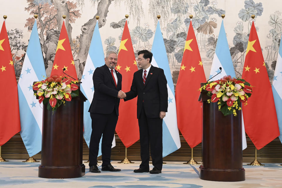 Honduras Foreign Minister Eduardo Enrique Reina Garcia, left, and Chinese Foreign Minister Qin Gang shake hands following the establishment of diplomatic relations between the two countries, during a joint statement after a ceremony at the Diaoyutai State Guesthouse in Beijing Sunday, March 26, 2023. Honduras formed diplomatic ties with China on Sunday after breaking off relations with Taiwan, which is increasingly isolated and now recognized by only 13 sovereign states, including Vatican City. (Greg Baker/Pool Photo via AP)