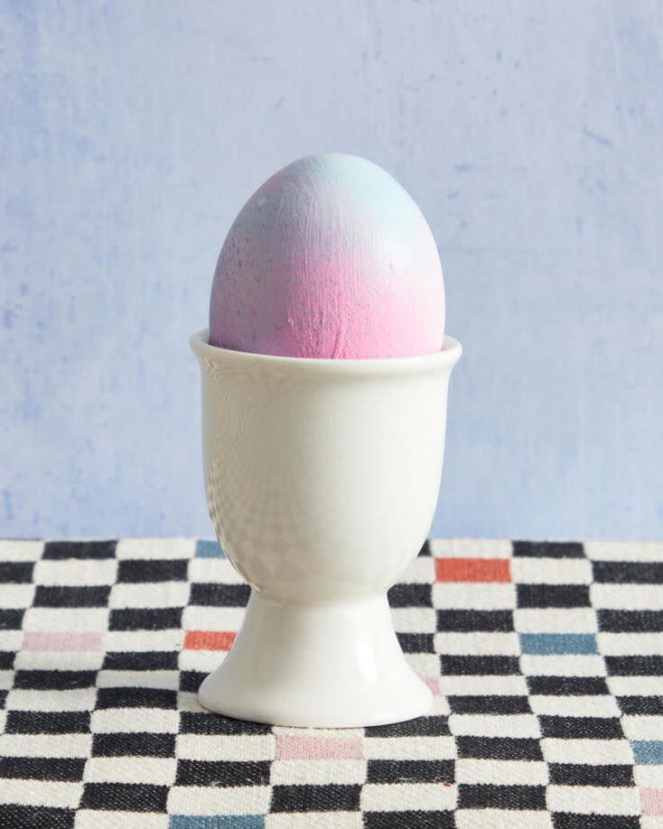 an easter egg decorated in pink, blue, and purple for taylor swift's lover album