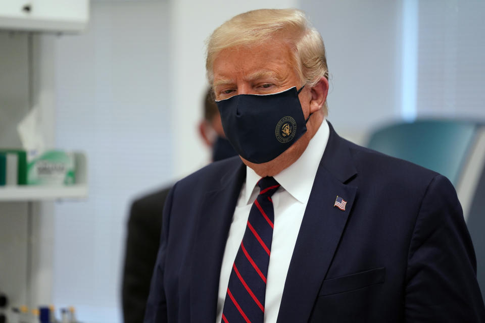 FILE - In this Monday, July 27, 2020 file photo, President Donald Trump wears a face mask as he participates in a tour at Fujifilm Diosynth Biotechnologies in Morrisville, N.C. On Friday, July 31, 2020, The Associated Press reported on stories circulating online incorrectly asserting Project Veritas captures Trump on video bashing his supporters. A parody account created and released the video, not Project Veritas, a conservative group known for using undercover tactics to reveal supposed liberal bias in the media. (AP Photo/Evan Vucci)