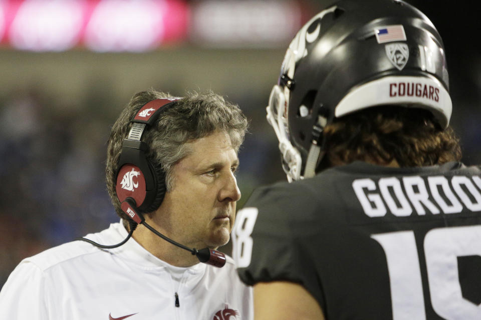 Washington State head coach Mike Leach, left, speaks with quarterback Anthony Gordon during the first half of an NCAA college football game against UCLA in Pullman, Wash., Saturday, Sept. 21, 2019. (AP Photo/Young Kwak)